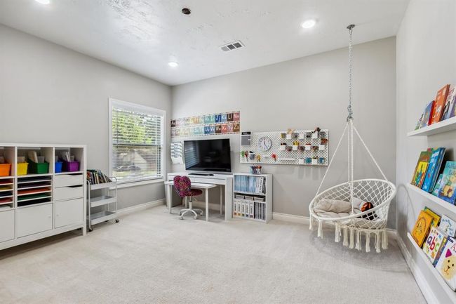 This secondary upstairs bedroom is currently serving as a dedicated school room. | Image 30