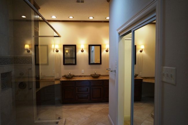 Bathroom featuring double vanity, recessed lighting, a stall shower, and tile patterned flooring | Image 15