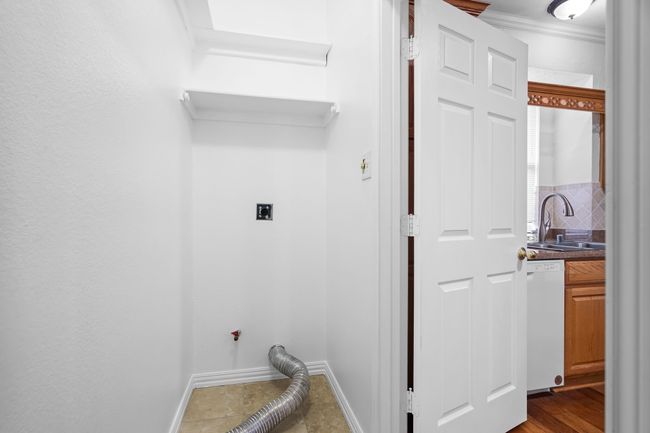 The dedicated laundry room is off of the kitchen. | Image 20