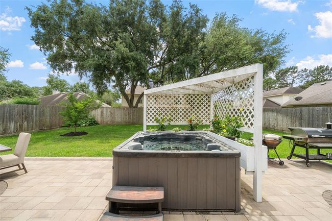 Enjoy the large patio with an inviting hot tub | Image 5