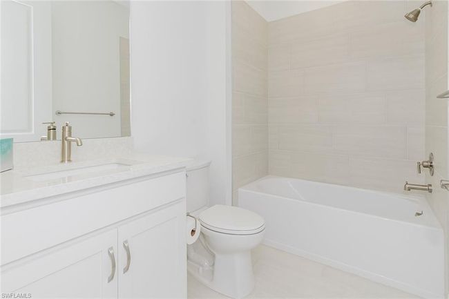 Full bath featuring vanity, tub / shower combination, and tile patterned floors | Image 24