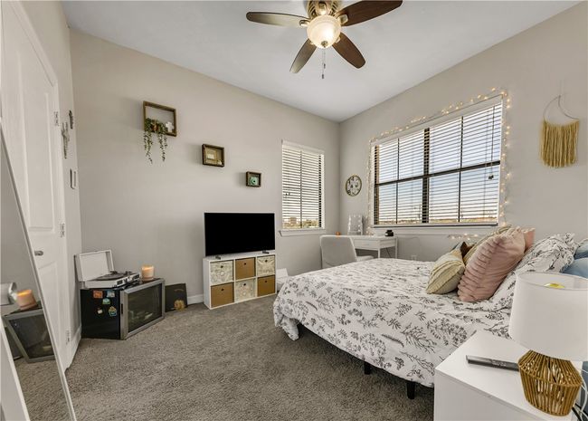 Carpeted bedroom featuring ceiling fan | Image 26