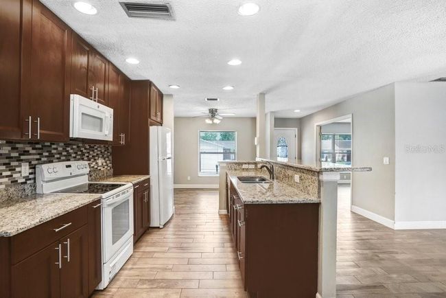 Kitchen with beautiful 42 inch cabinets, granite countertops and beautiful backsplash | Image 6