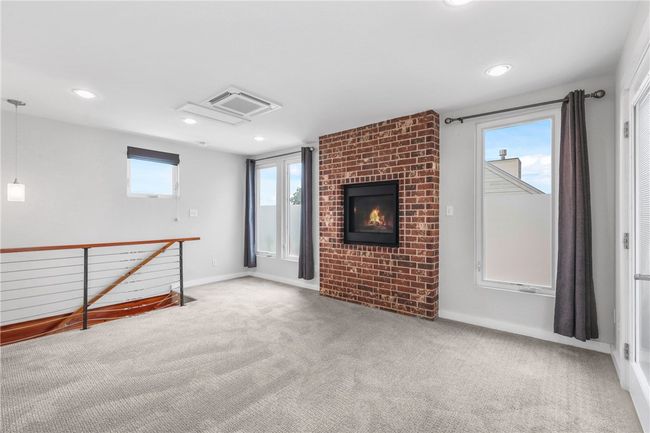 Unfurnished living room featuring carpet floors, plenty of natural light, recessed lighting, and a brick fireplace | Image 15