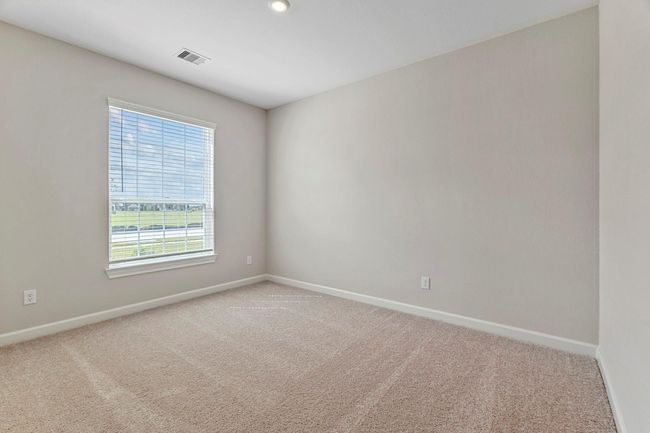 This secondary bedroom is a tranquil escape that offers enough space for whatever you need it to be. Whether you use it as a home office or a comfortable guest room, this space invites relaxation and reflection. | Image 11