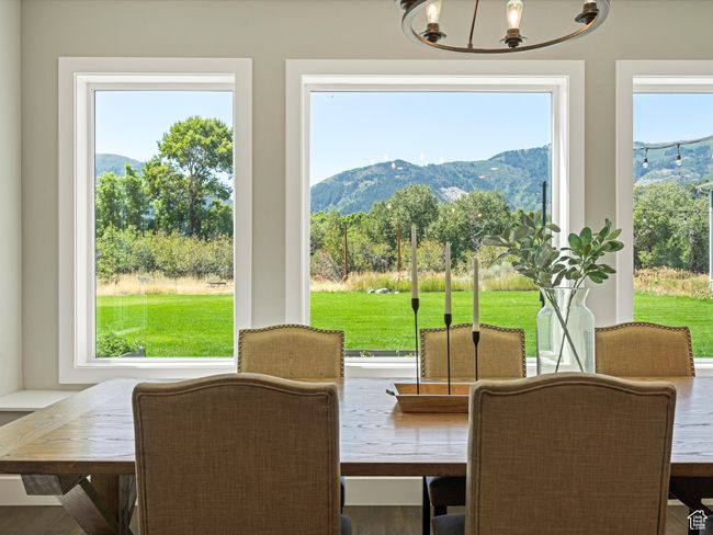 Dining space with a mountain view and a chandelier | Image 15