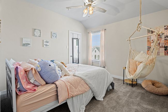 Bedroom with baseboards, a ceiling fan, carpet, and vaulted ceiling | Image 22