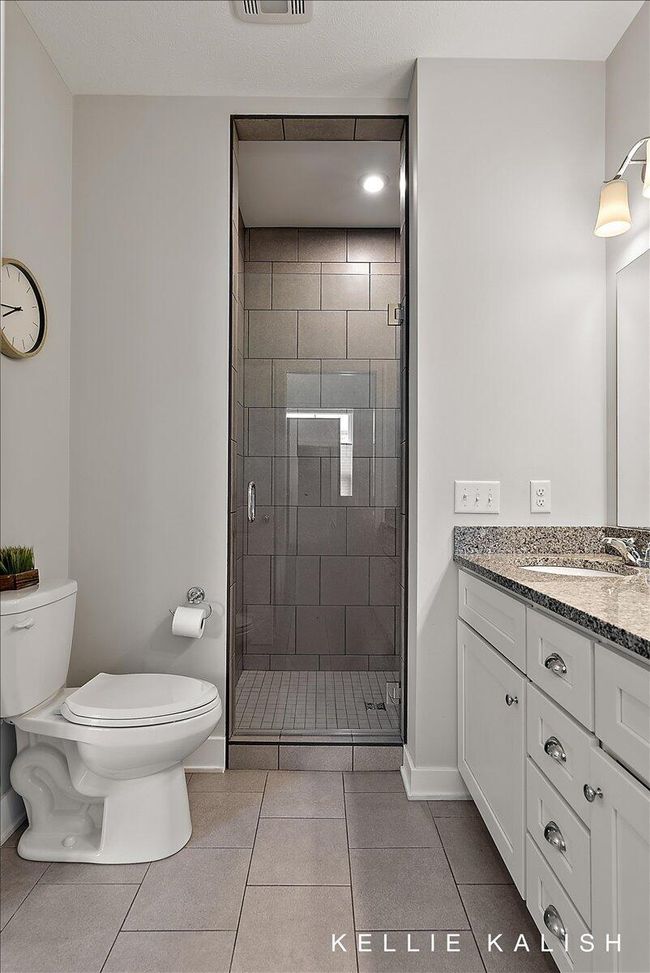 Spa-like primary bathroom with walk-in shower, double sink set in quartz, and walk-in closet. | Image 21
