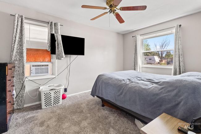 Carpeted bedroom featuring cooling unit and ceiling fan | Image 11