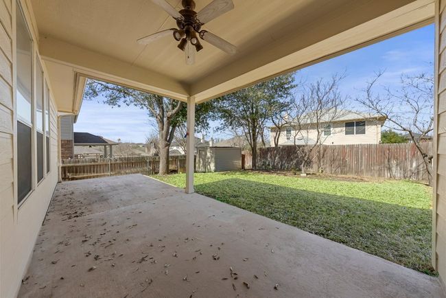 View of patio / terrace with an outbuilding, a fenced backyard, a storage unit, and ceiling fan | Image 18