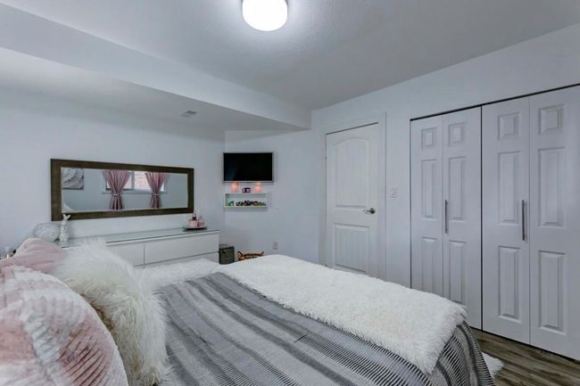 Bedroom featuring wood finished floors and a closet | Image 14