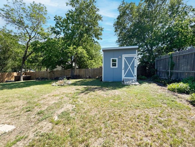 View of yard with a storage shed and an outdoor structure | Image 17
