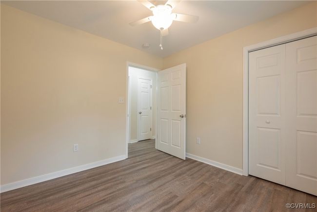 Unfurnished bedroom with baseboards, a closet, wood finished floors, and ceiling fan | Image 19