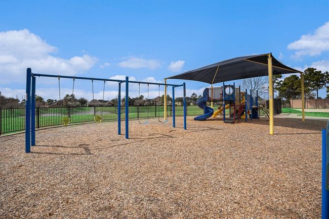 Enjoy the community playground area, complete with swings, slides, and shaded seating—perfect for outdoor fun and relaxation. | Image 33