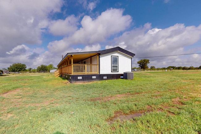View of side of property with central air condition unit and a lawn | Image 34