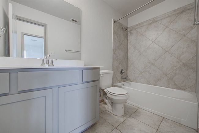 Full bathroom with toilet, shower / bathtub combination, vanity, and tile patterned flooring | Image 25