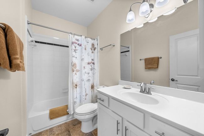 Full bathroom with shower / bath combo, toilet, and vanity | Image 25