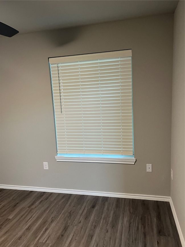 Spare room featuring wood finished floors and baseboards | Image 7