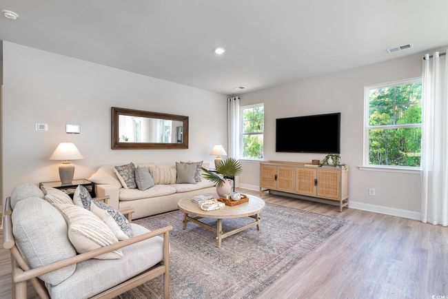 Living room featuring light wood-style flooring, recessed lighting, baseboards, and visible vents | Image 10