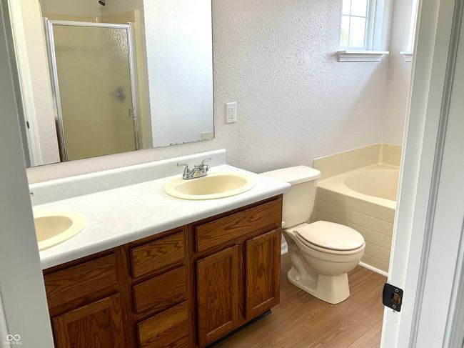Primary bath has stand up shower as well as a garden tub and dual vanities. | Image 24