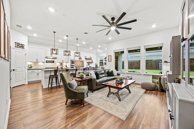 Living area featuring recessed lighting, light wood finished floors, plenty of natural light, and a ceiling fan | Image 5