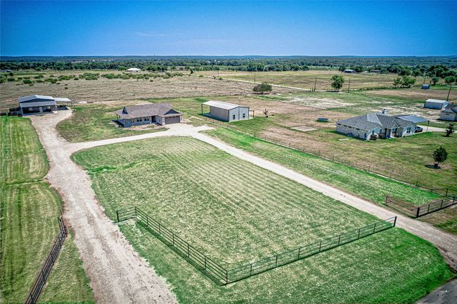 Aerial view of pipe fencing across the front and right side as well as sparsely populated area featuring extensive farmland | Image 39