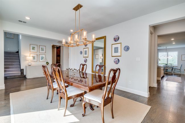 Formal dining has upgraded light fixture and easy access to the kitchen. Take note of the upgraded flooring throughout. | Image 6
