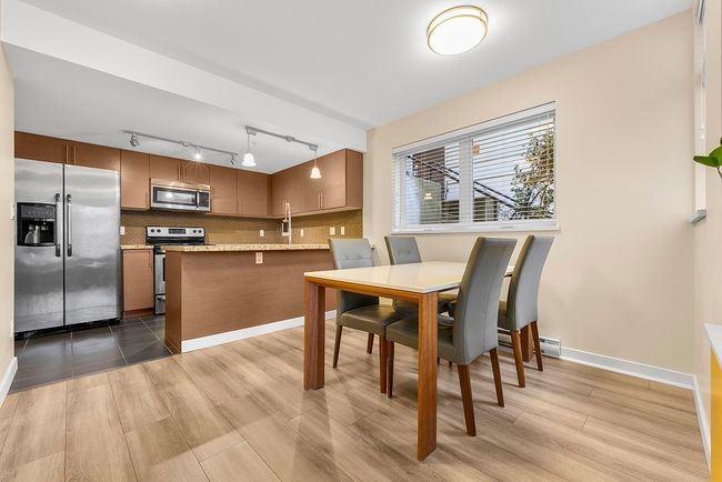 Dining area with wood finished floors and baseboards | Image 8