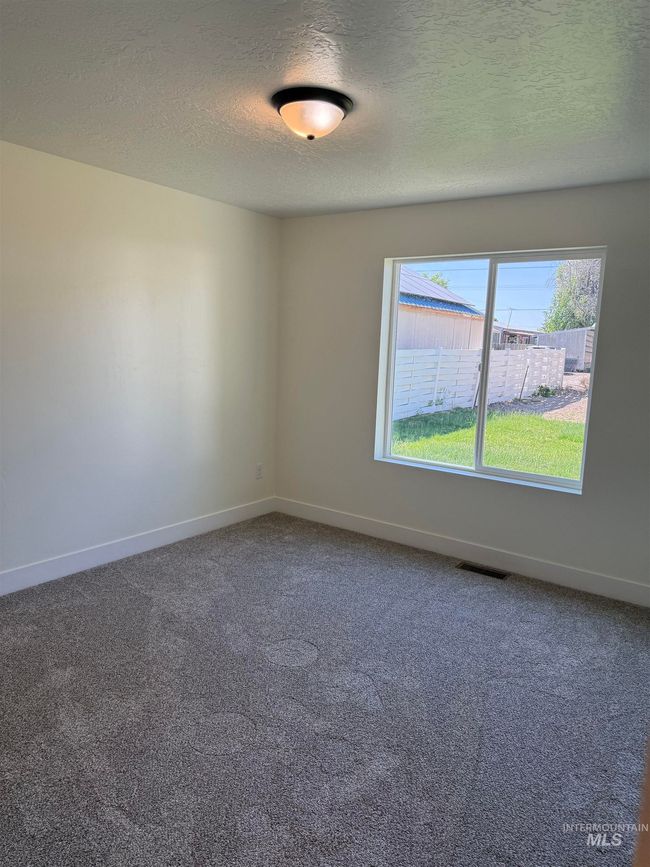 Empty room featuring carpet and a textured ceiling | Image 5
