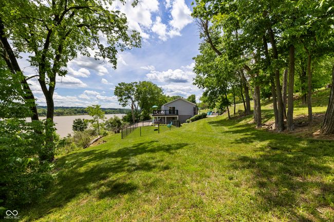 view of green lawn with a deck with water view and stairway | Image 55