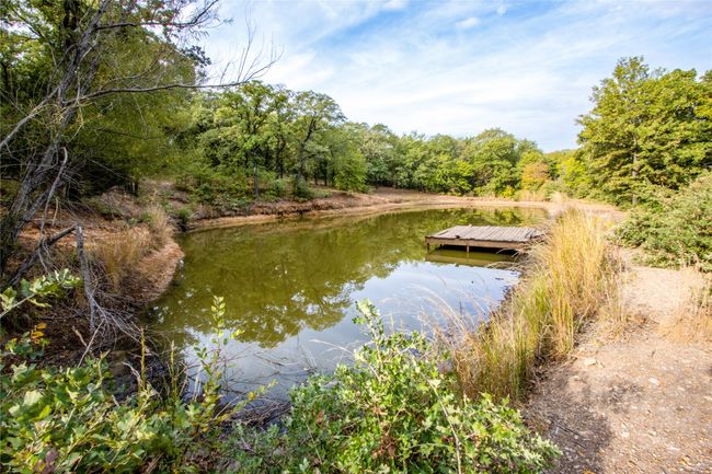 View of dock featuring a water view and a wooded view | Image 39