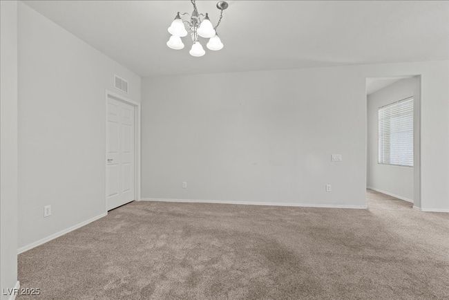 Empty room with a chandelier and carpet | Image 17