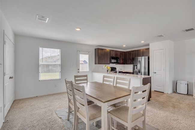 Dining room with light carpet and recessed lighting | Image 14