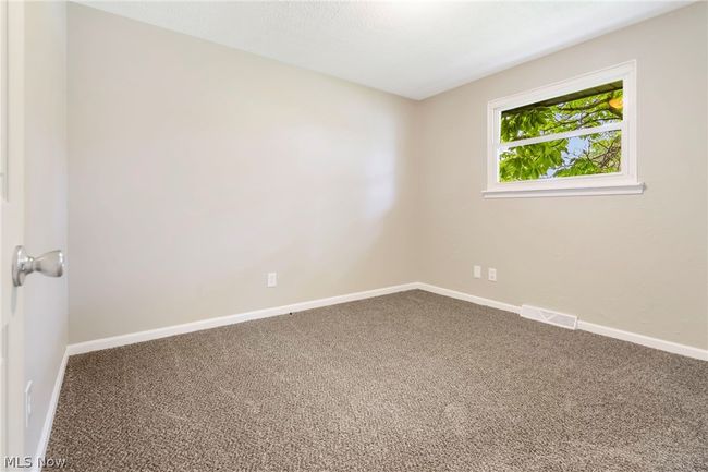 Corridor featuring carpet and a textured ceiling | Image 13