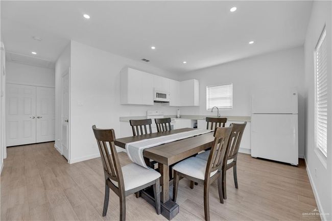 Dining area featuring light wood-type flooring and sink | Image 15