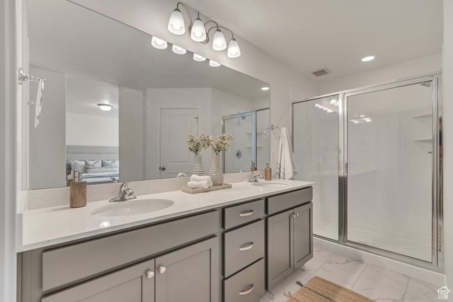 Bathroom with a shower stall, marble finish floor, double vanity, and a sink | Image 8