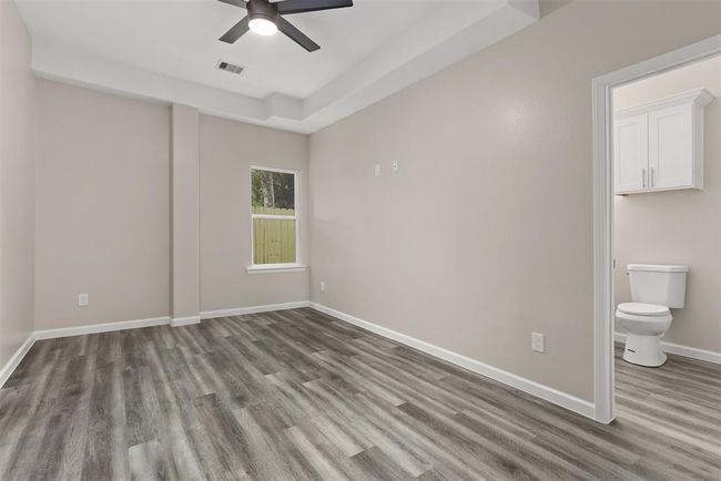 Bedroom 4, which is a second primary suite, location downstairs with access from the garage and the exterior through the bathroom | Image 28