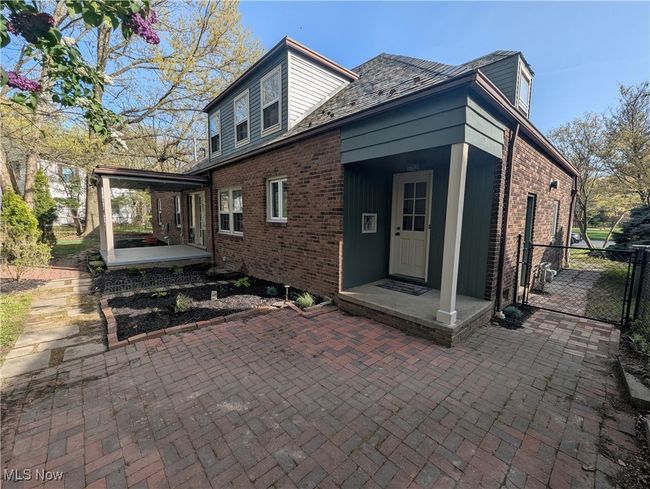 Back of house with brick siding and a gate | Image 15