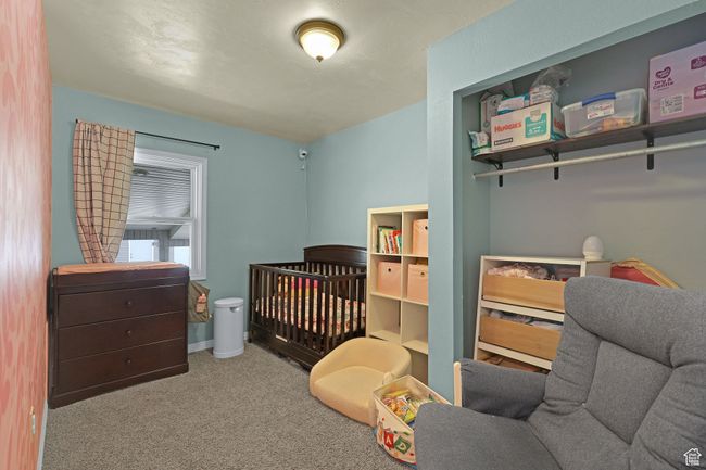 Bedroom featuring carpet and a crib | Image 15