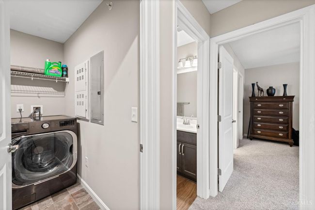 Laundry room located across from second bedroom, full bath in hall with shower and tub. | Image 19