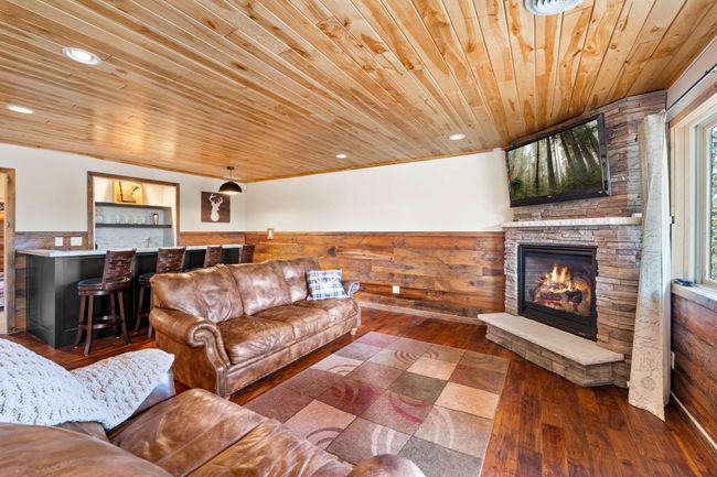 Easily entertain family and friends in this open space...gather around the fireplace or the brand new wet bar! | Image 26
