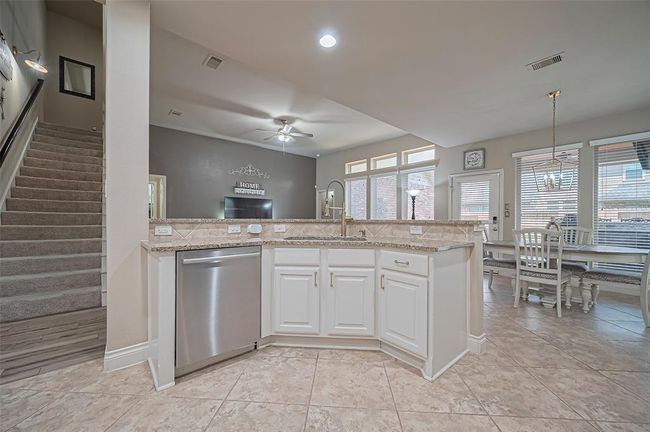 This well-planned layout includes a second staircase near the kitchen, making upstairs access quick and convenient. | Image 12