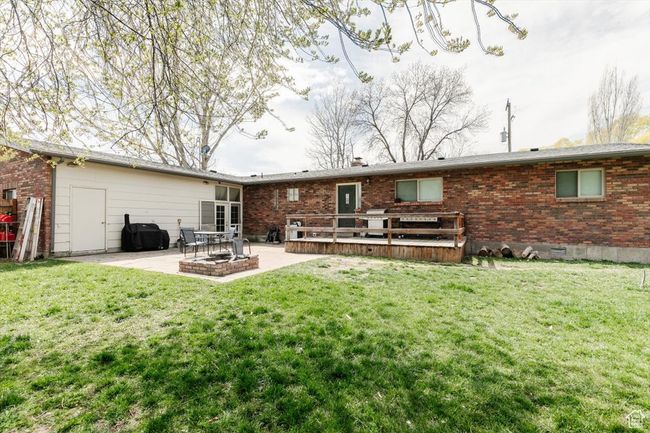 Back of property featuring a patio area, brick siding, crawl space, and a lawn | Image 34