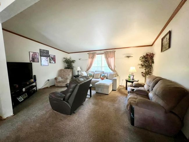 Carpeted living room featuring crown molding | Image 7