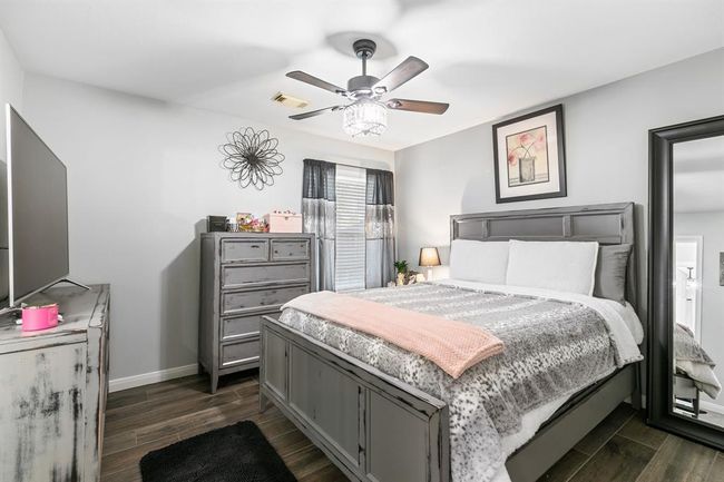 This third bedroom features a ceiling fan, walk in closet and tile floors. | Image 33