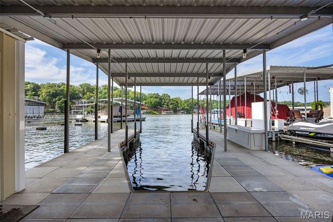 Dock with a water view and boat lift | Image 36