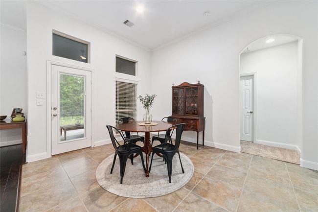 Great size breakfast room looking out to the covered patio. | Image 18