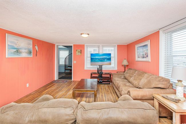 Living room with wood finished floors and a textured ceiling | Image 10