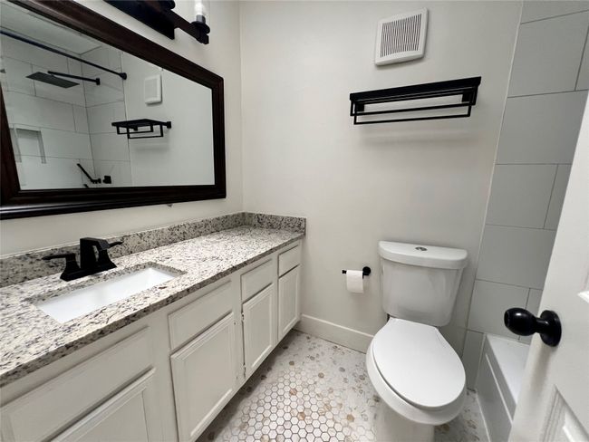 Full bathroom featuring baseboards, a shower, toilet, and vanity | Image 23