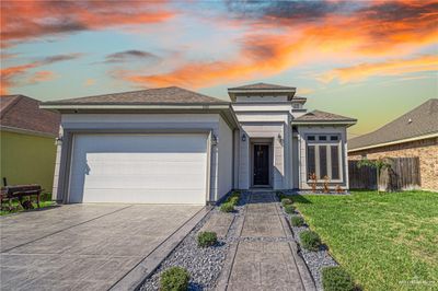 Prairie-style house featuring a garage and a lawn | Image 2